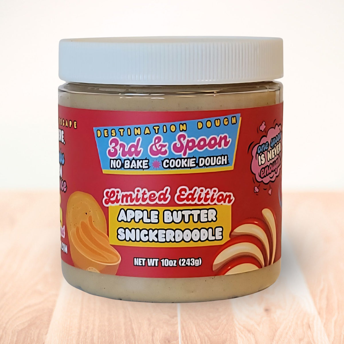 10 oz jar of 3rd & Spoon apple butter snickerdoodle edible cookie dough on a light wooden counter