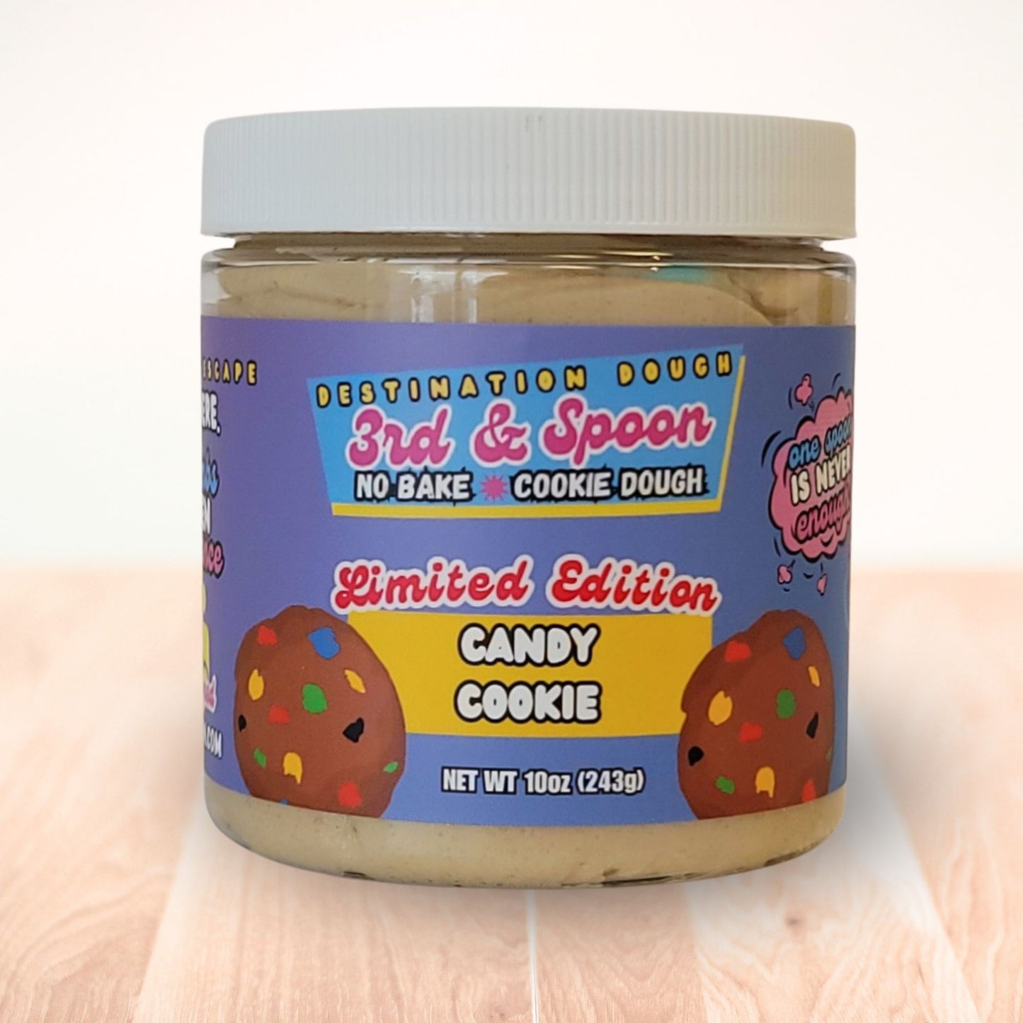 10 oz jar of 3rd & Spoon candy cookie edible cookie dough on a light wooden counter