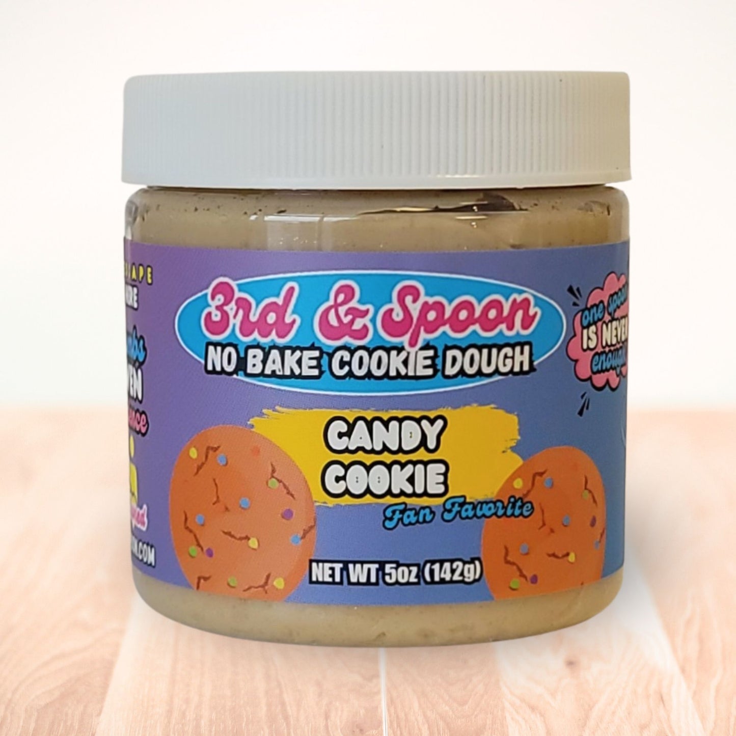 5 oz jar of 3rd & Spoon candy cookie edible cookie dough on a light wooden counter