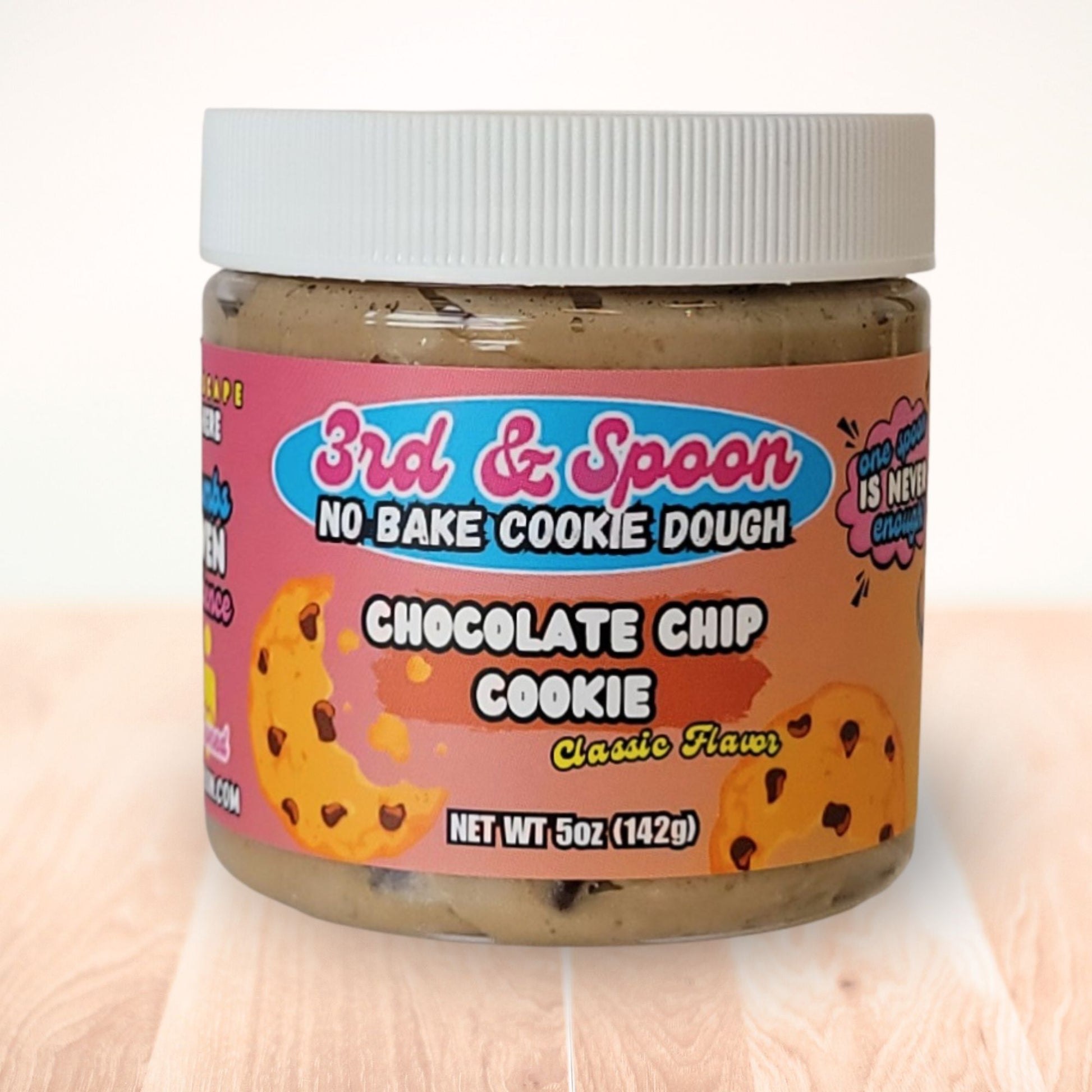 5 oz jar of 3rd & Spoon chocolate chip edible cookie dough on a light wooden counter