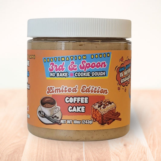 10 oz jar of 3rd & Spoon coffee cake edible cookie dough on a light wooden counter