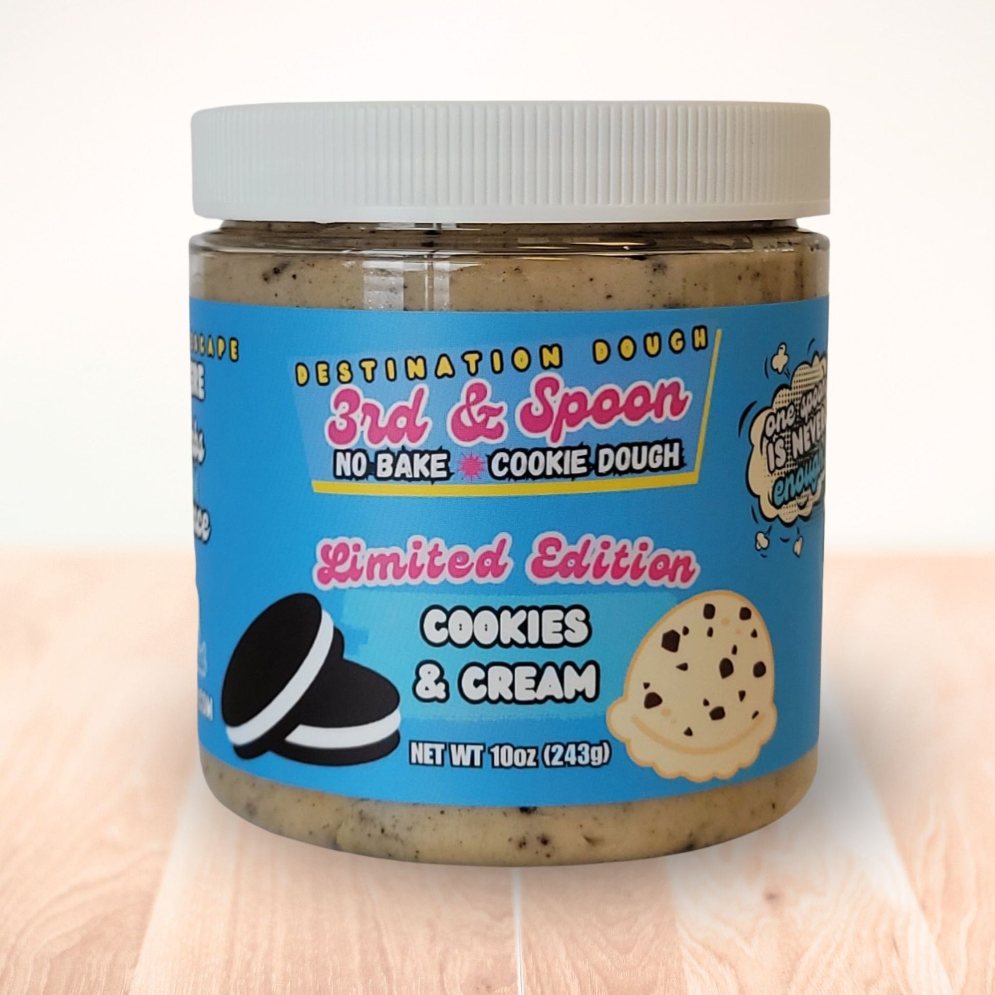 10 oz jar of 3rd & Spoon cookies & cream edible cookie dough on a light wooden counter