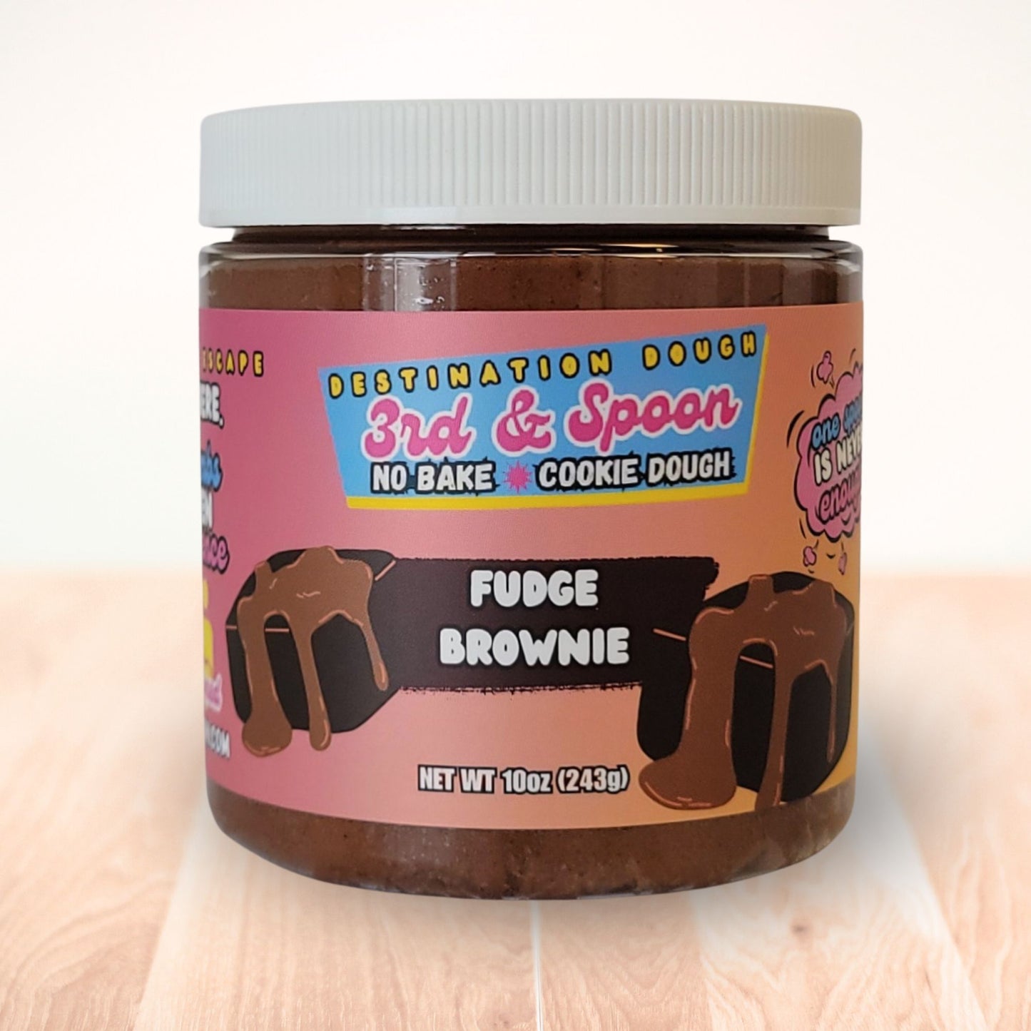 10 oz jar of 3rd & Spoon fudge brownie edible cookie dough on a light wooden counter