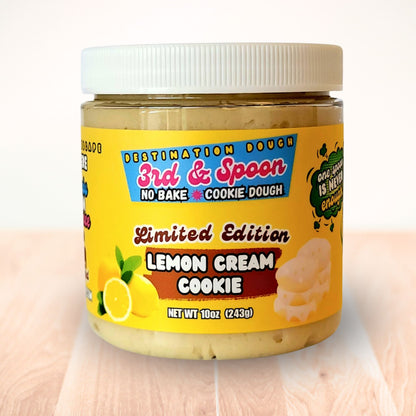 10 oz jar of 3rd & Spoon lemon cream edible cookie dough on a light wooden counter