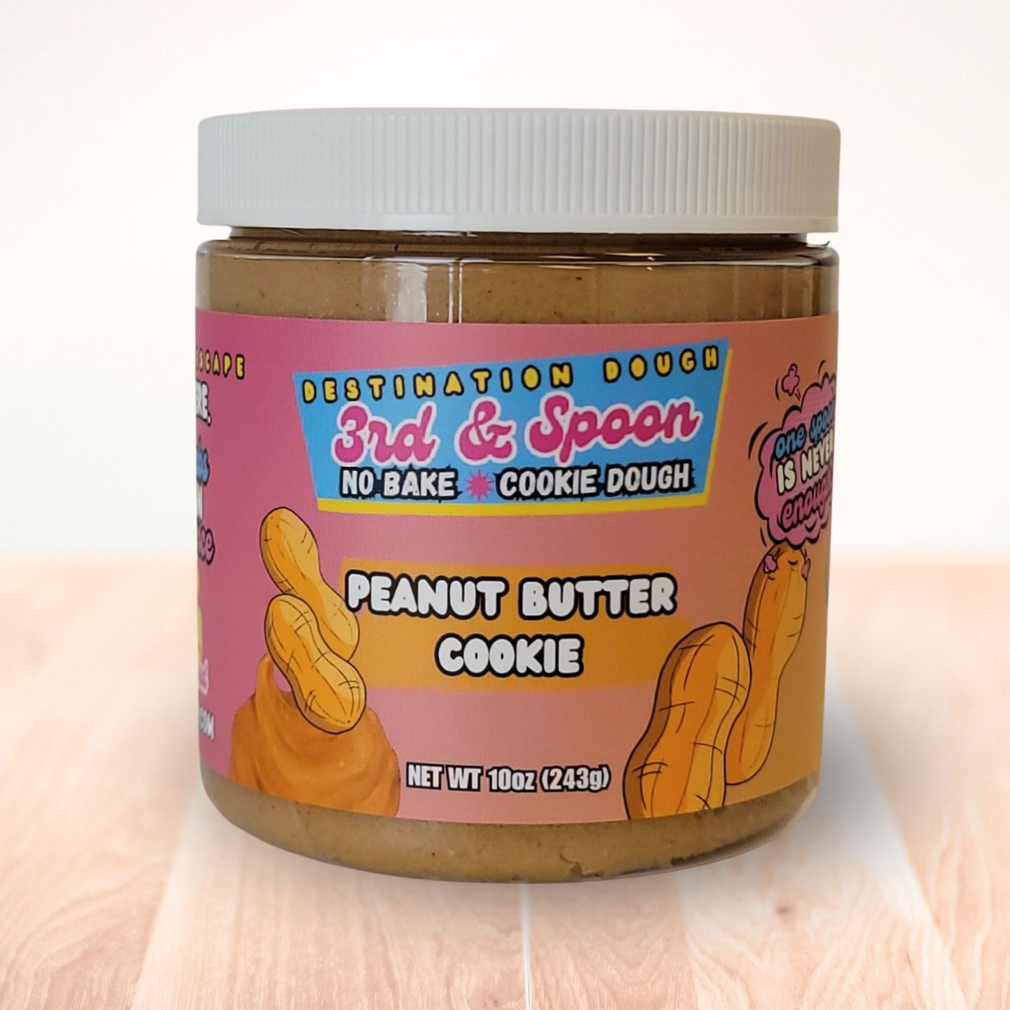 10 oz jar of 3rd & Spoon peanut butter edible cookie dough on a light wooden counter