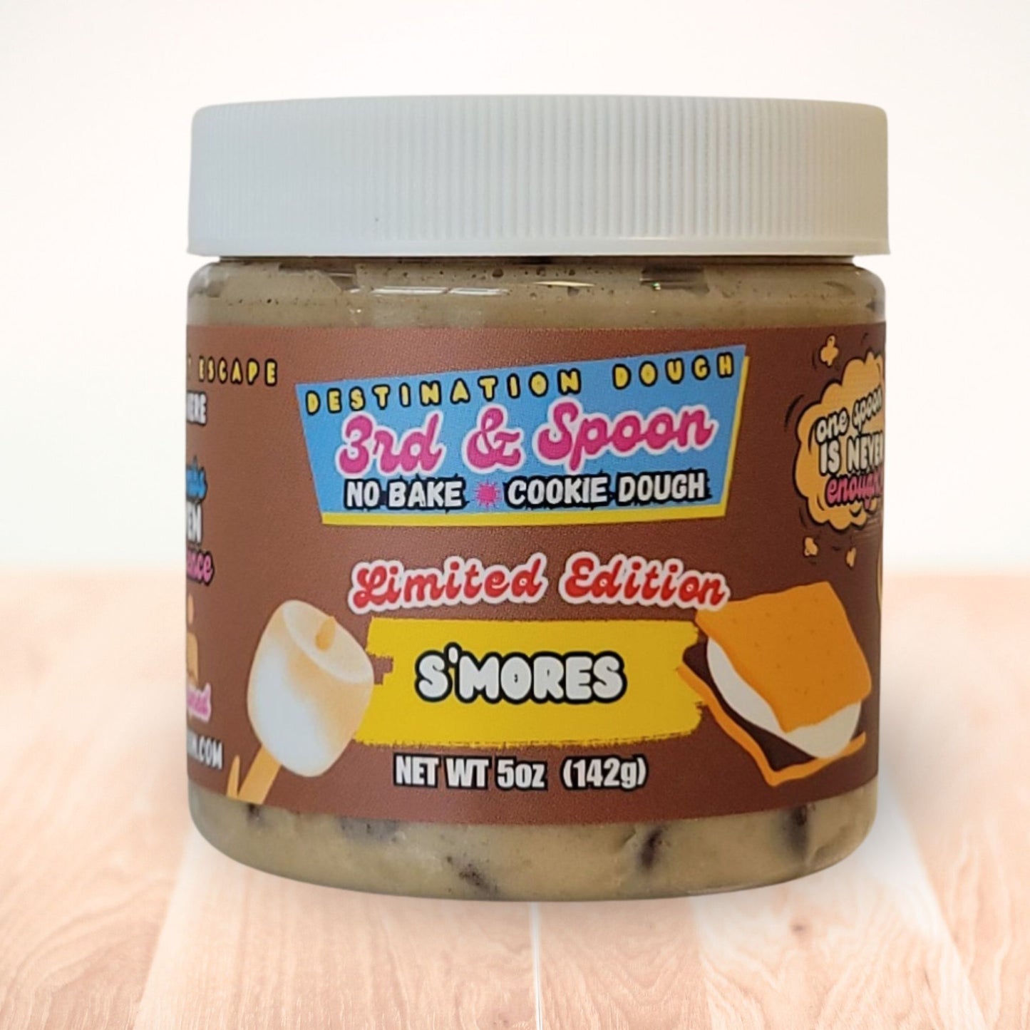 10 oz jar of 3rd & Spoon s'mores edible cookie dough on a light wooden counter