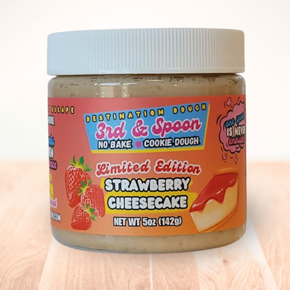 5 oz jar of 3rd & Spoon strawberry cheesecake edible cookie dough on a light wooden counter